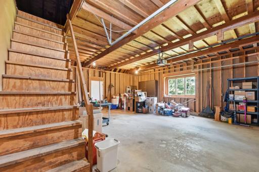 Garage with steps leading to extra storage
