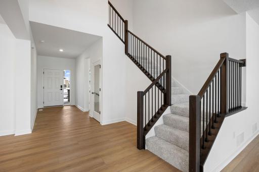 (Photo of a similar home, actual finishes may vary) The kitchen is just behind the Great Room, making it easy to quickly grab snacks and drinks while watching movies or on the go