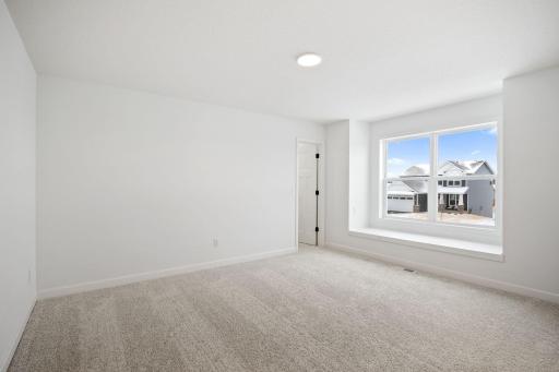 (Photo of a similar home, actual finishes may vary) The home includes a number of bedrooms to accommodate residents looking for extra space.
