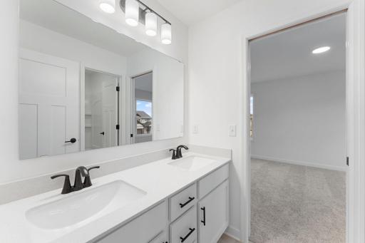 This Jack-and-Jill bathroom connects two bedrooms on the second floor, with dual sinks to accommodate shared living.