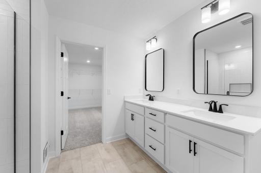 A freestanding tub offers rejuvenating spa-like experiences while a glass-enclosed shower streamlines daily cleansing rituals