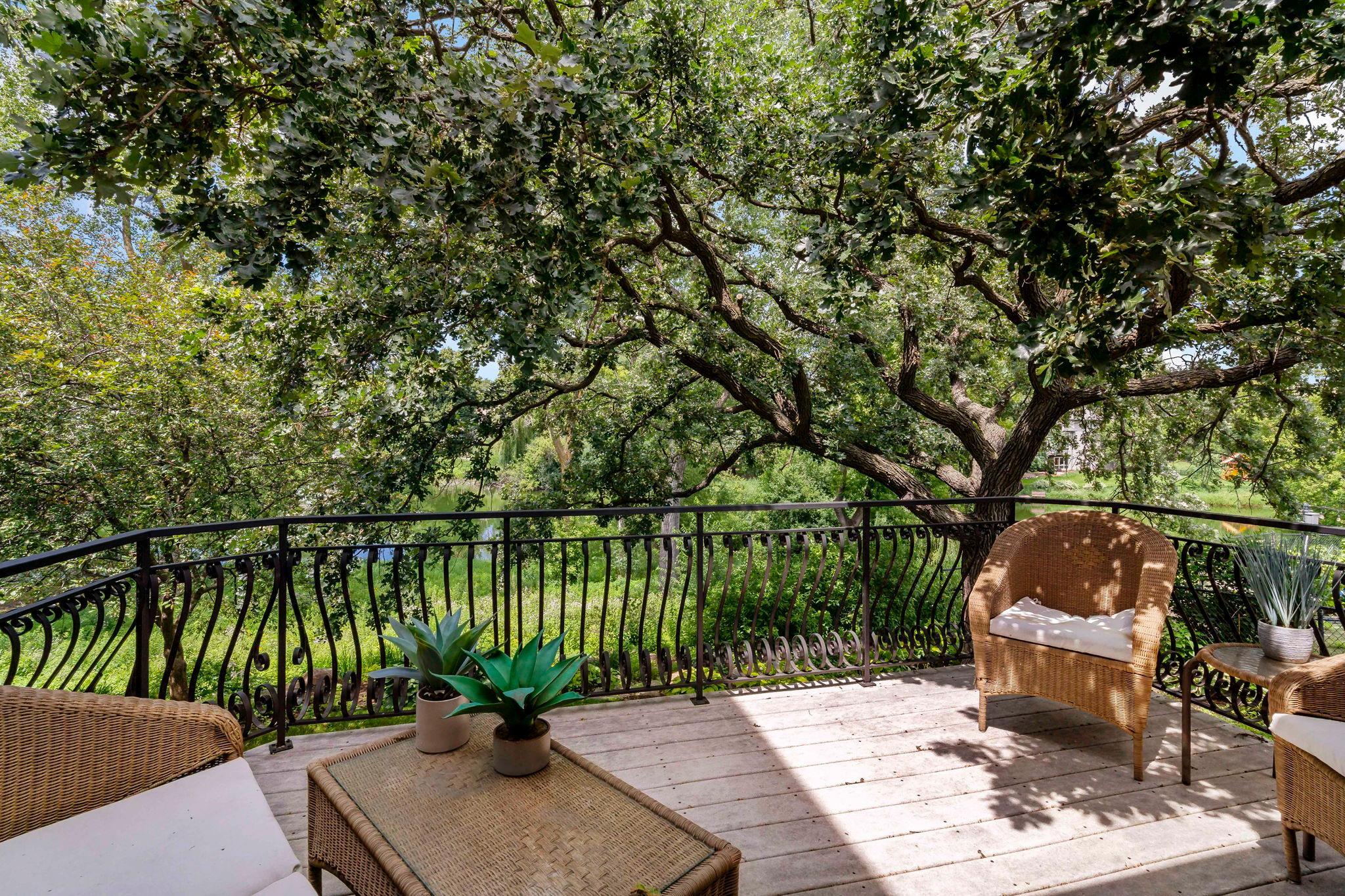 Private deck off the sunroom with views of the pond