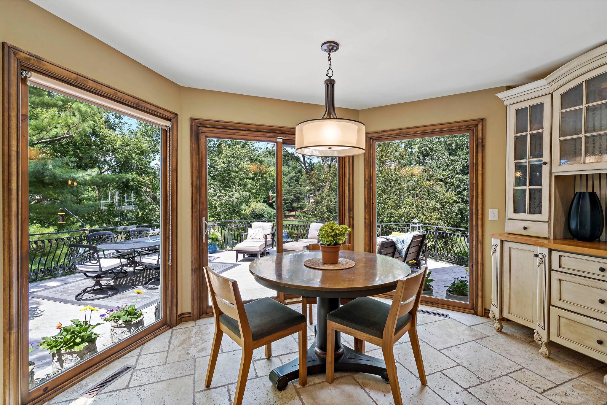Informal dining space leads to the deck and gorgeous backyard