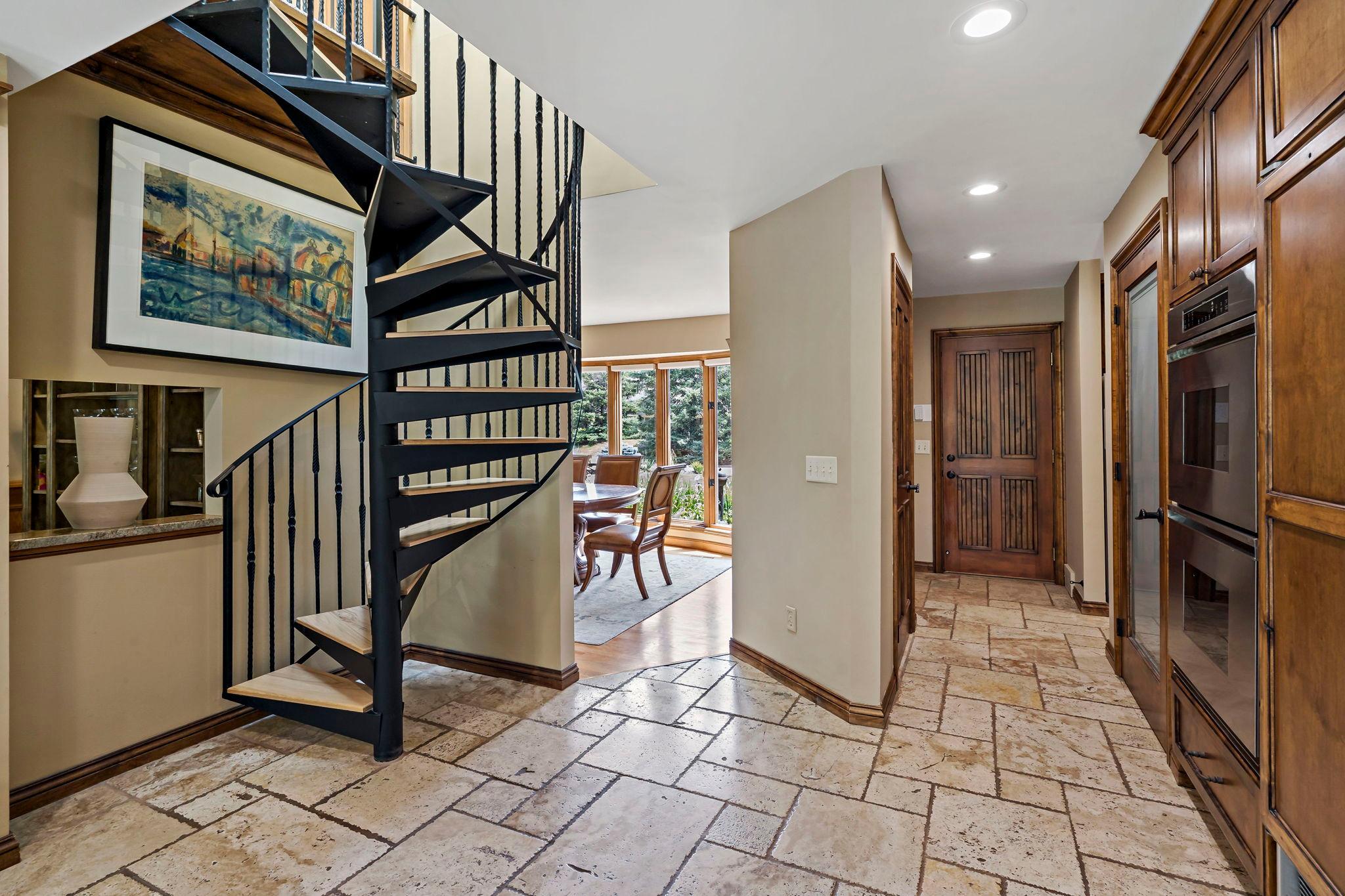 Spiral back staircase adds a whimsical twist to the kitchen