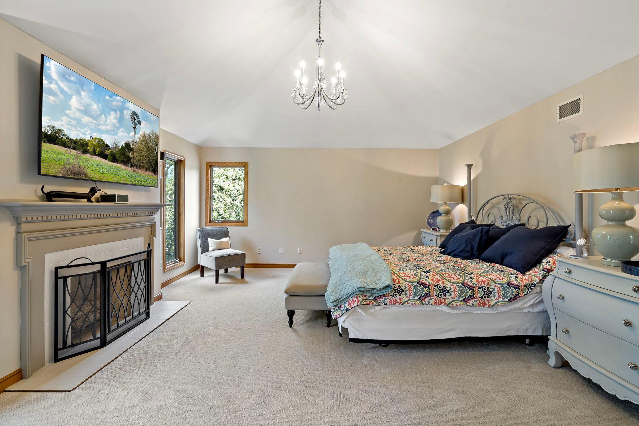 Primary bedroom has cathedral ceiling, large windows, new carpet