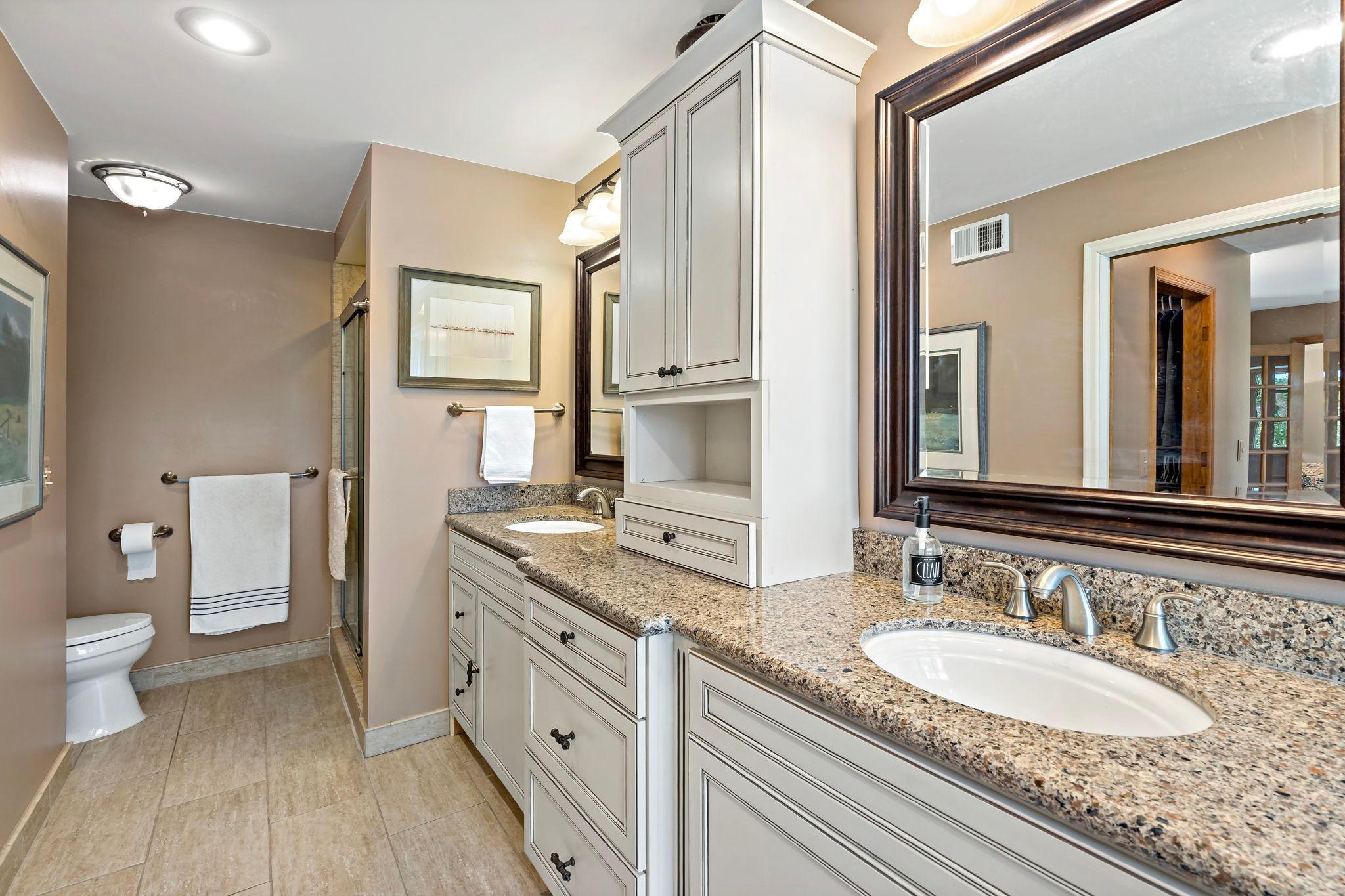 Private primary bath includes two sinks, shower, and separate bath