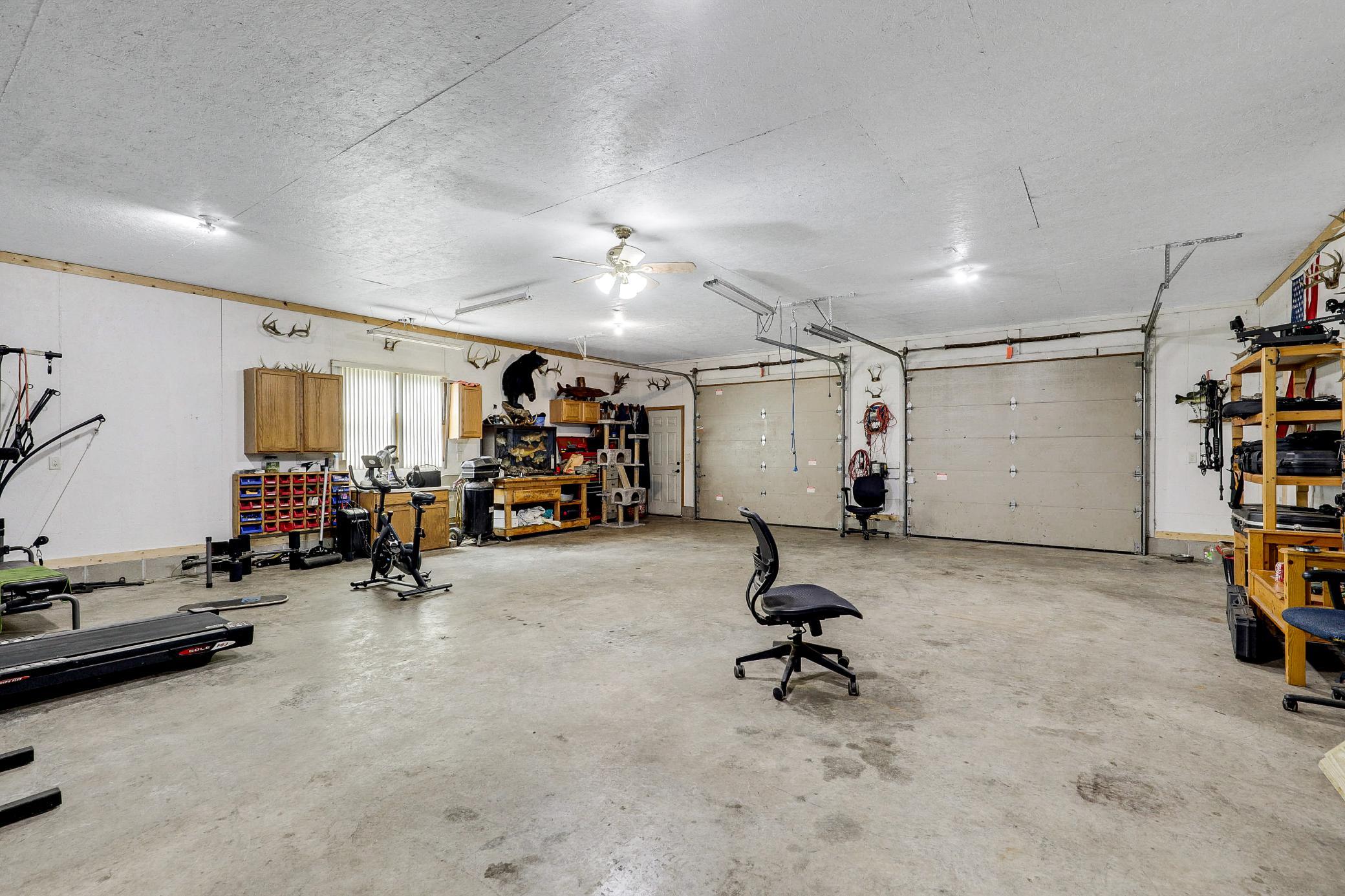 The 34’ by 60’ stick-framed outbuilding with concrete floors and 220V service, is divided in half with a heated workshop on one side, and cold storage on the other. Additional attic storage space spans the entire length of outbuilding.