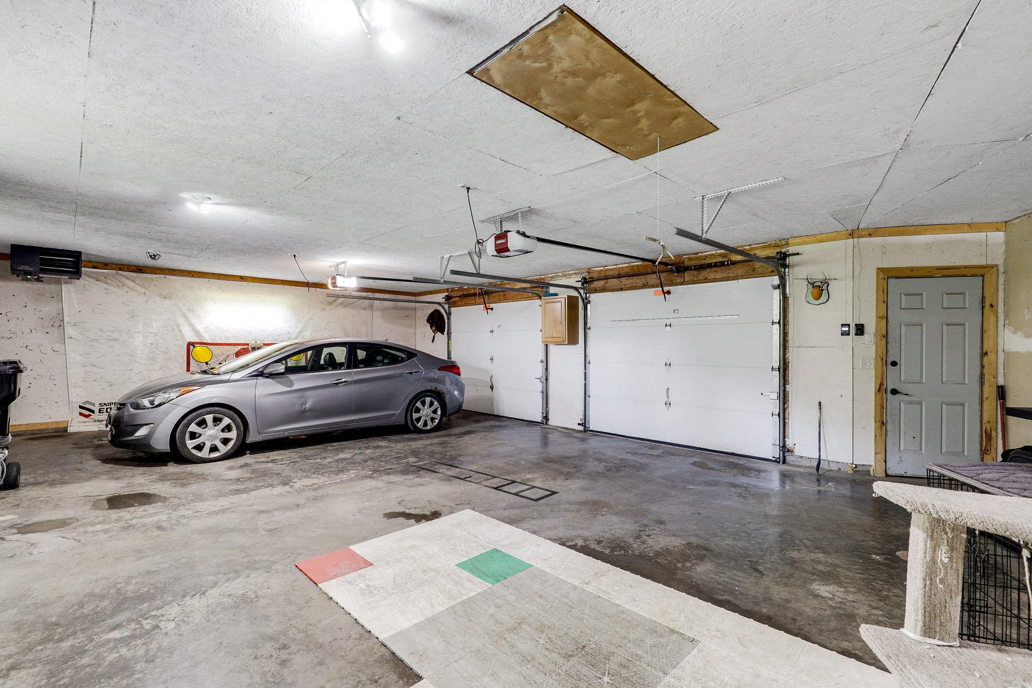 An attached, heated, two car garage with room for extra storage connects through the lower level, and abundant closets and storage spaces are found throughout the home.