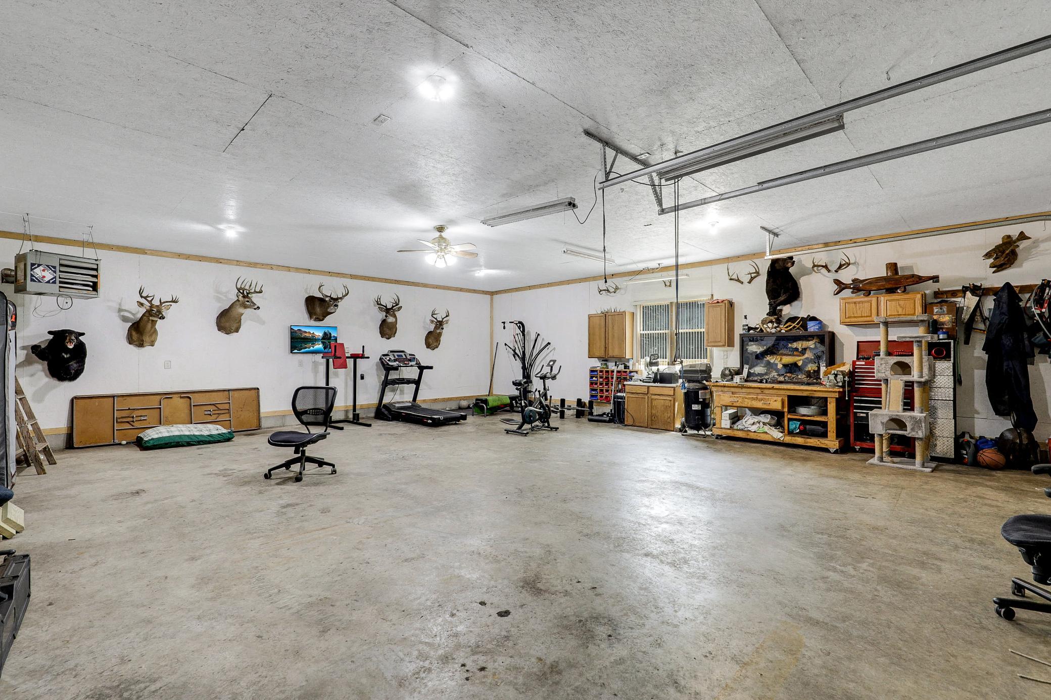 The 34’ by 60’ stick-framed outbuilding with concrete floors and 220V service, is divided in half with a heated workshop on one side, and cold storage on the other. Additional attic storage space spans the entire length of outbuilding.