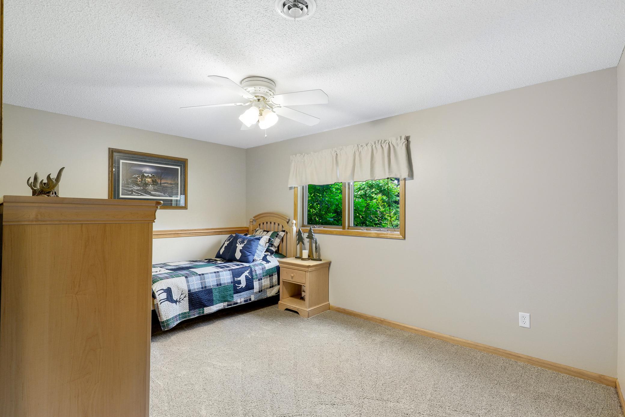 The walkout lower level extends the living space with two additional bedrooms, a large family room with a gas fireplace and an office nook, and a full laundry room that also functions as a mudroom.