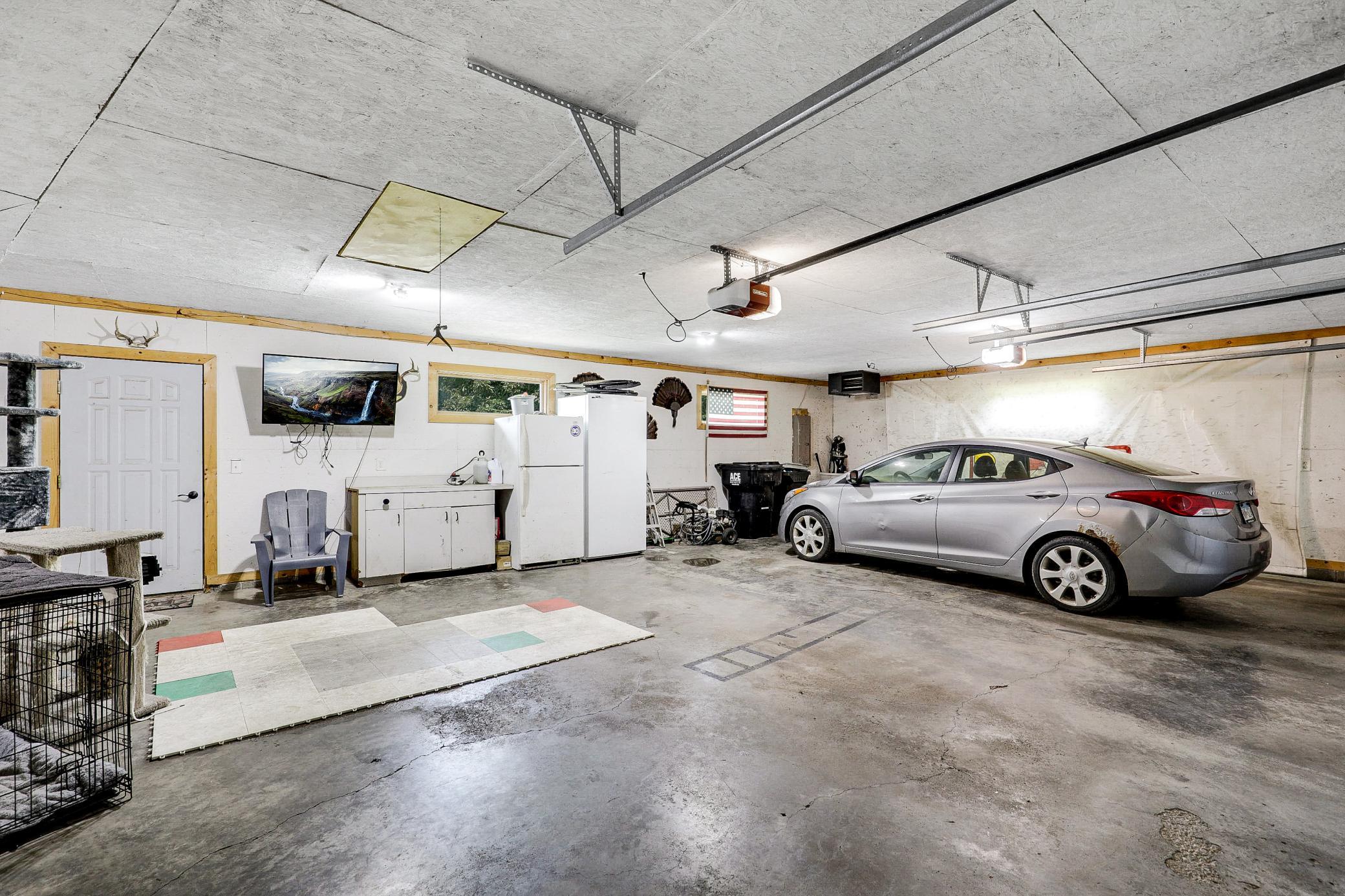 An attached, heated, two car garage with room for extra storage connects through the lower level, and abundant closets and storage spaces are found throughout the home.