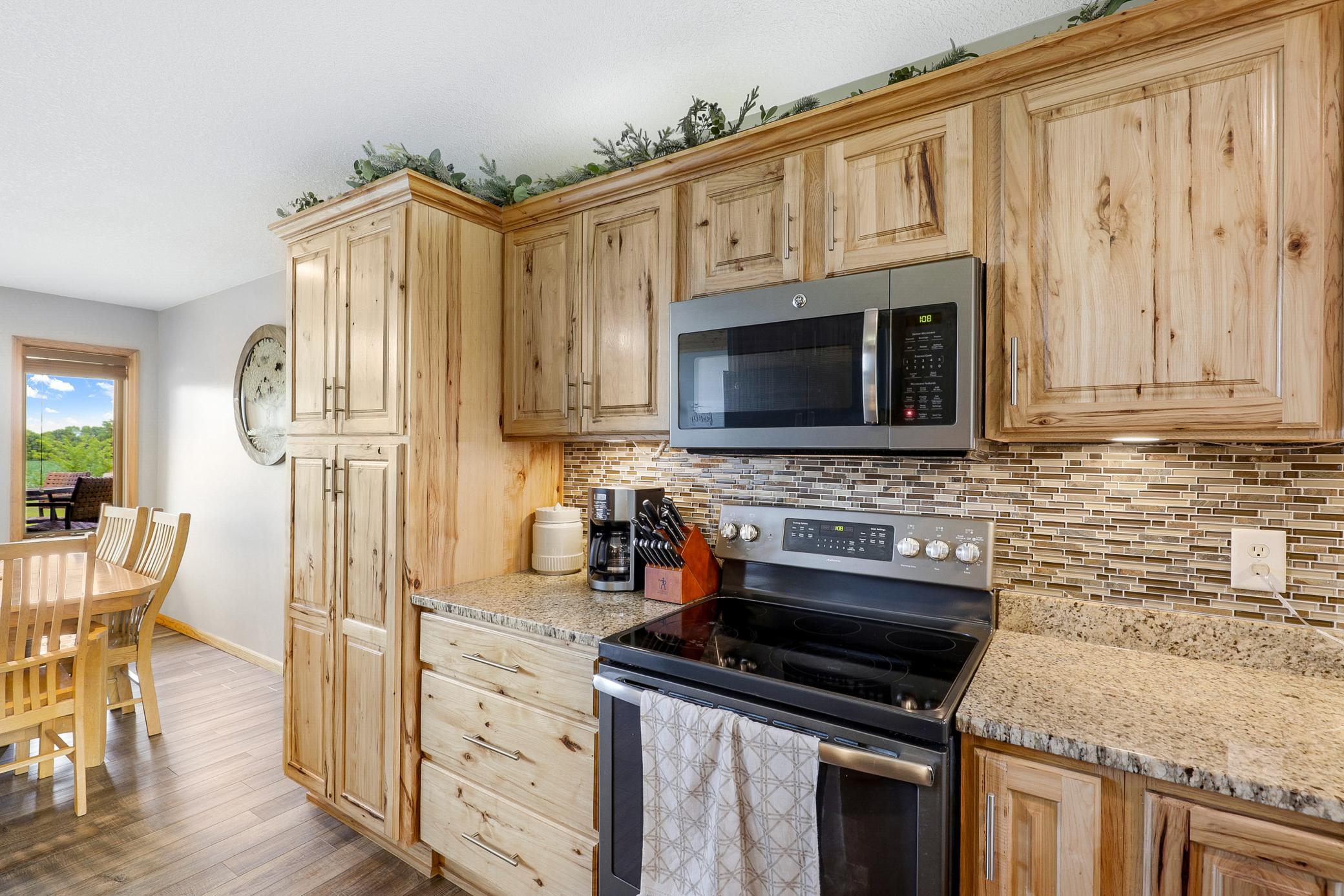A 2017 renovation opened the kitchen, dining, and living areas, which included refaced cabinetry, new LVP flooring, granite countertops, new GE appliances, and a fresh knockdown ceiling.