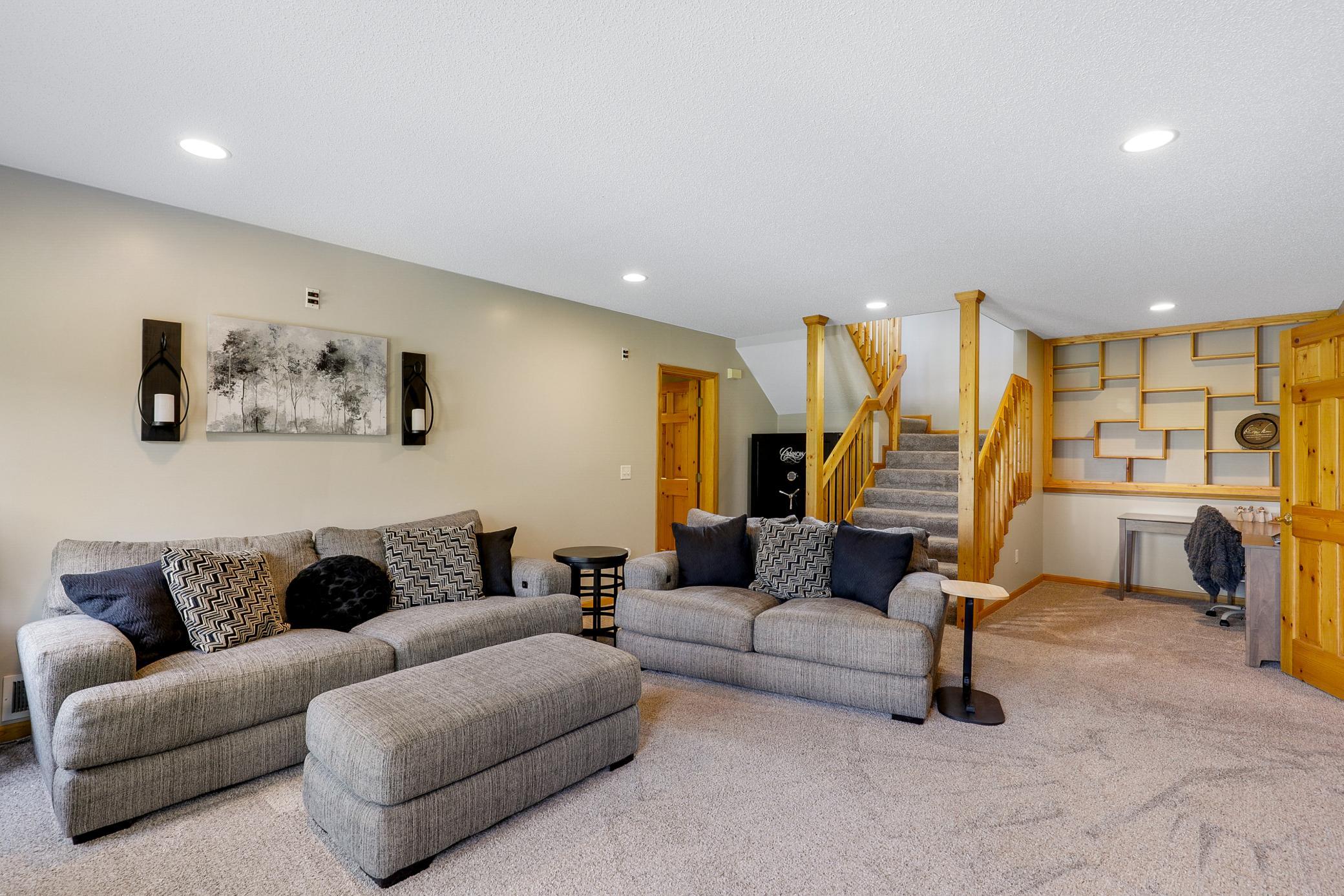 The walkout lower level extends the living space with two additional bedrooms, a large family room with a gas fireplace and an office nook, and a full laundry room that also functions as a mudroom.