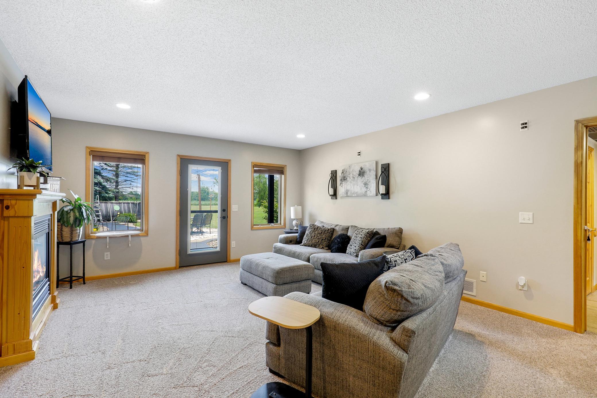 The walkout lower level extends the living space with two additional bedrooms, a large family room with a gas fireplace and an office nook, and a full laundry room that also functions as a mudroom.