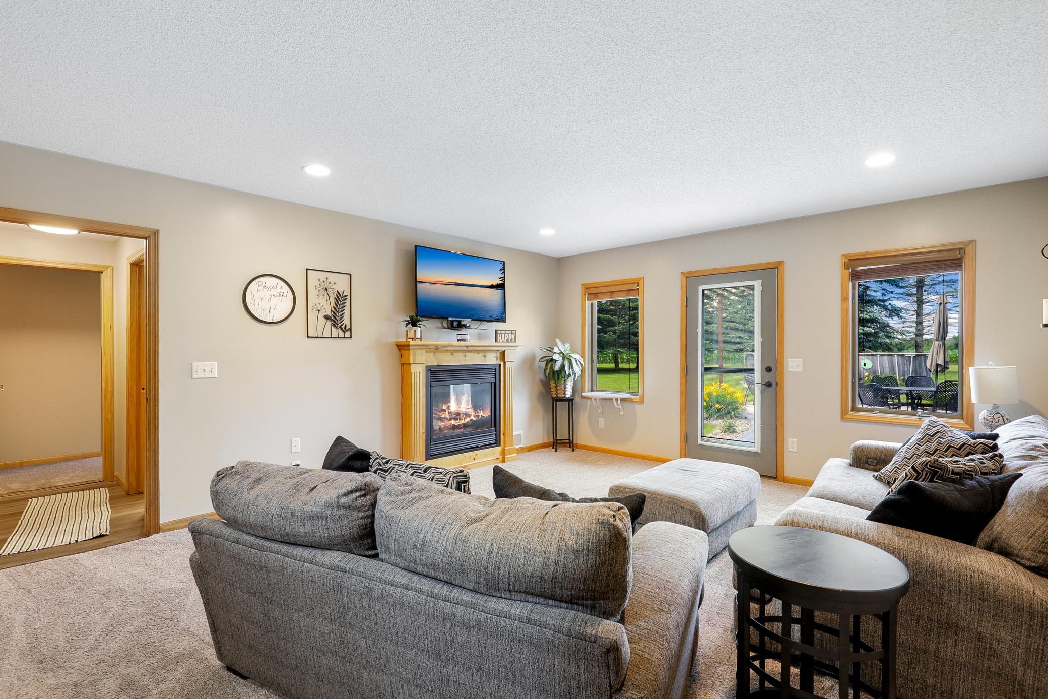 The walkout lower level extends the living space with two additional bedrooms, a large family room with a gas fireplace and an office nook, and a full laundry room that also functions as a mudroom.