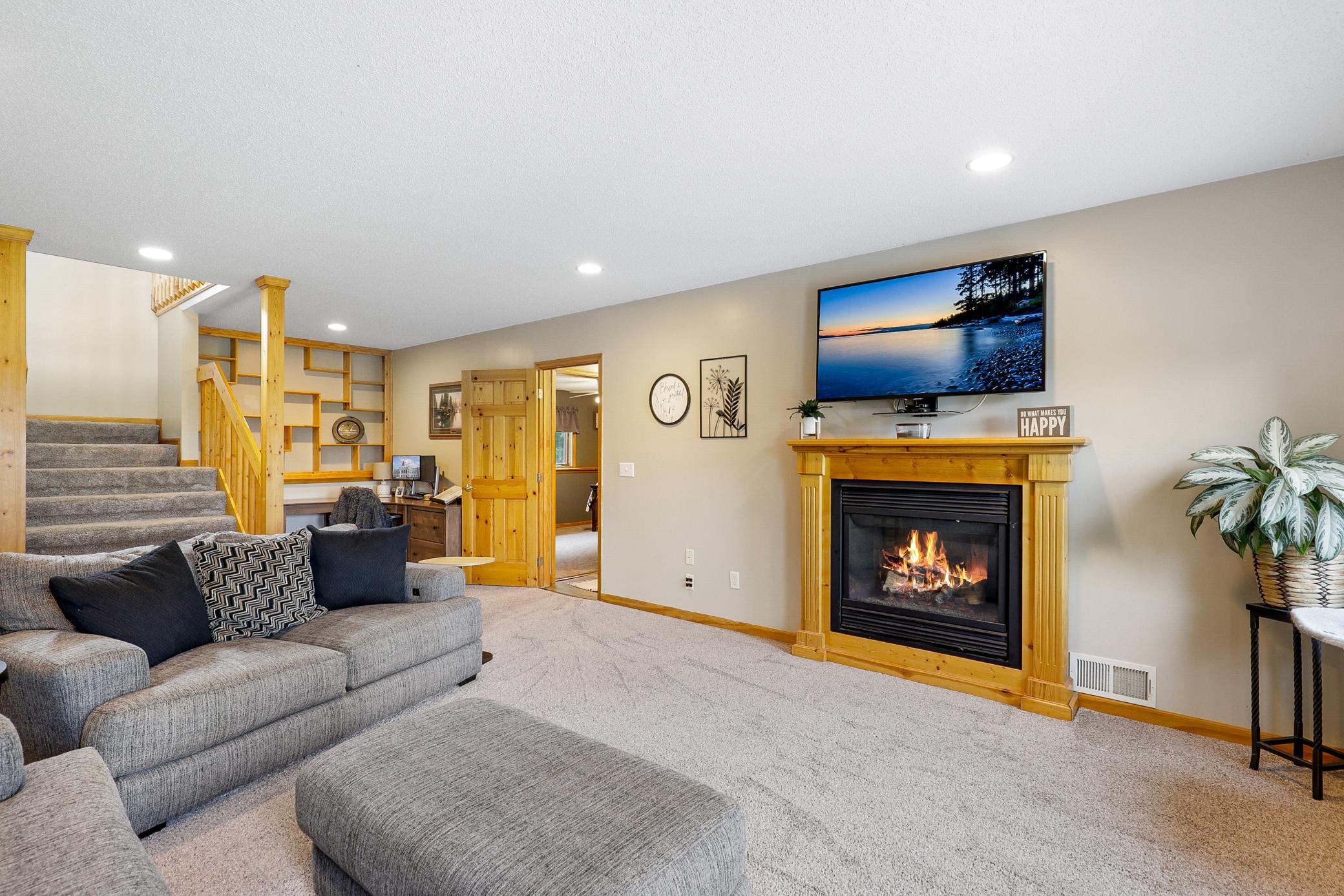 The walkout lower level extends the living space with two additional bedrooms, a large family room with a gas fireplace and an office nook, and a full laundry room that also functions as a mudroom.