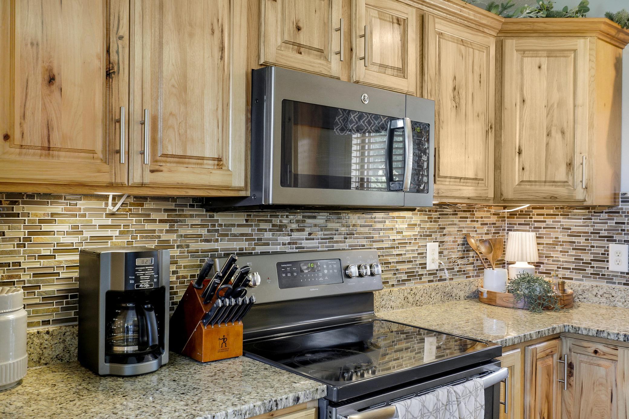 A 2017 renovation opened the kitchen, dining, and living areas, which included refaced cabinetry, new LVP flooring, granite countertops, new GE appliances, and a fresh knockdown ceiling.