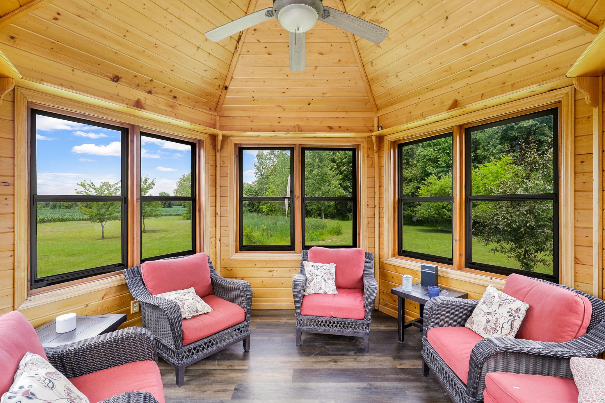 A deck off the main level extends to a gazebo and a large concrete patio, creating an ideal setting for entertaining or unwinding while taking in the peaceful surroundings.