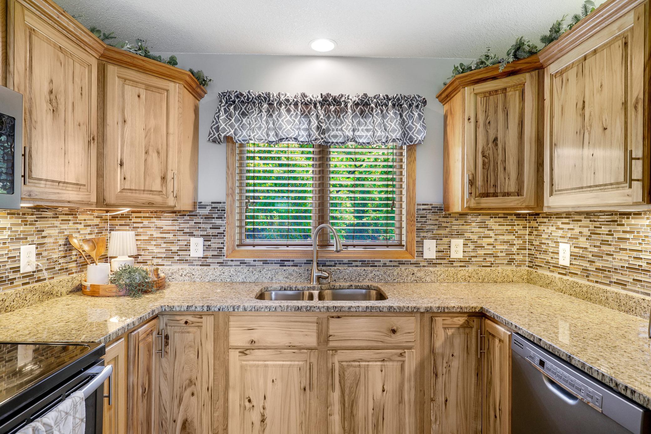 A 2017 renovation opened the kitchen, dining, and living areas, which included refaced cabinetry, new LVP flooring, granite countertops, new GE appliances, and a fresh knockdown ceiling.