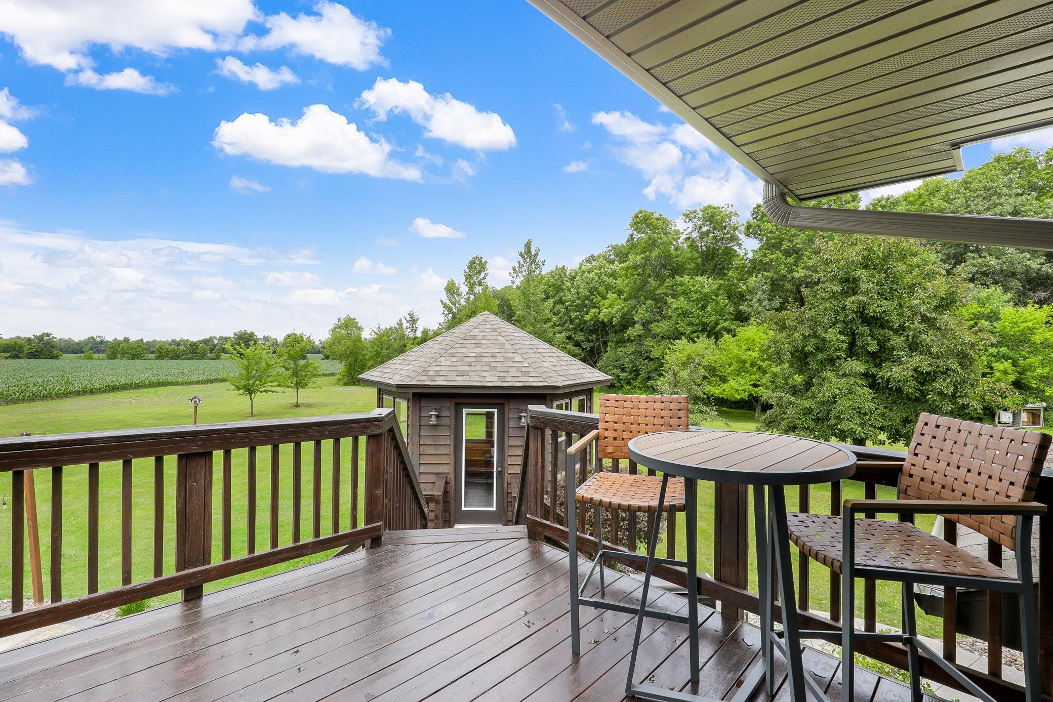 A deck off the main level extends to a gazebo and a large concrete patio, creating an ideal setting for entertaining or unwinding while taking in the peaceful surroundings.