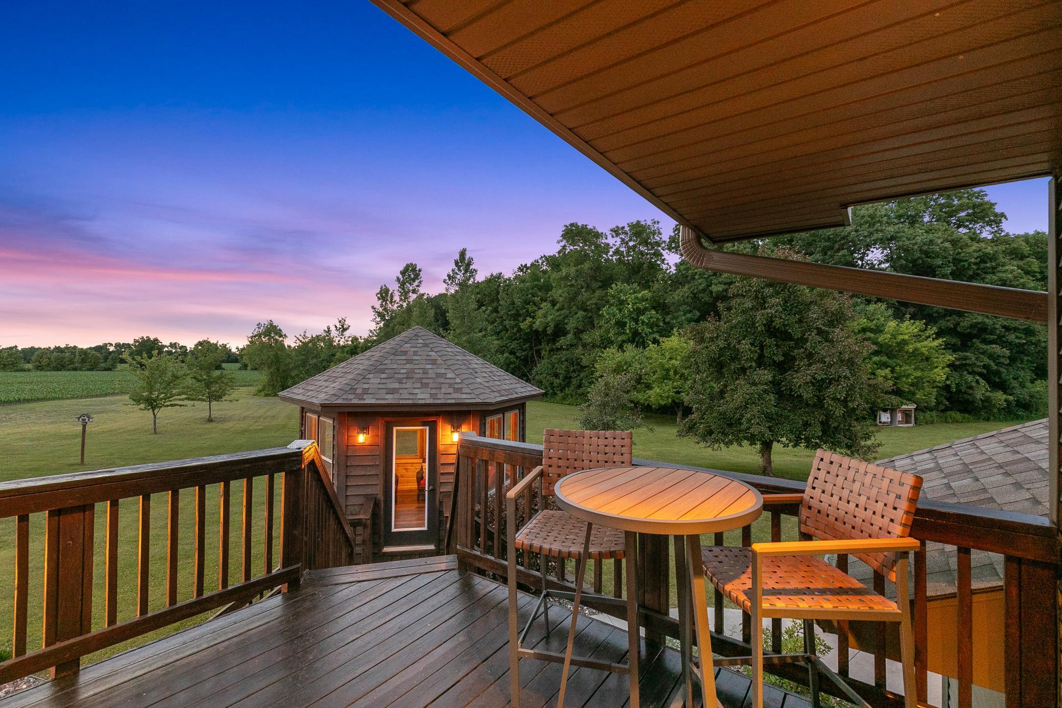 A deck off the main level extends to a gazebo and a large concrete patio, creating an ideal setting for entertaining or unwinding while taking in the peaceful surroundings.