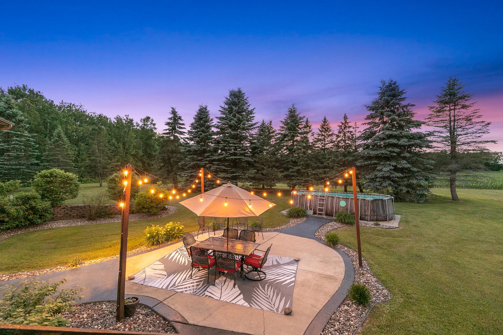 A deck off the main level extends to a gazebo and a large concrete patio, creating an ideal setting for entertaining or unwinding while taking in the peaceful surroundings.