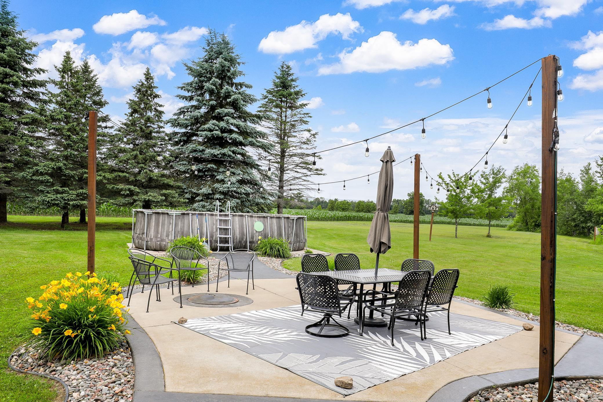 A deck off the main level extends to a gazebo and a large concrete patio, creating an ideal setting for entertaining or unwinding while taking in the peaceful surroundings.