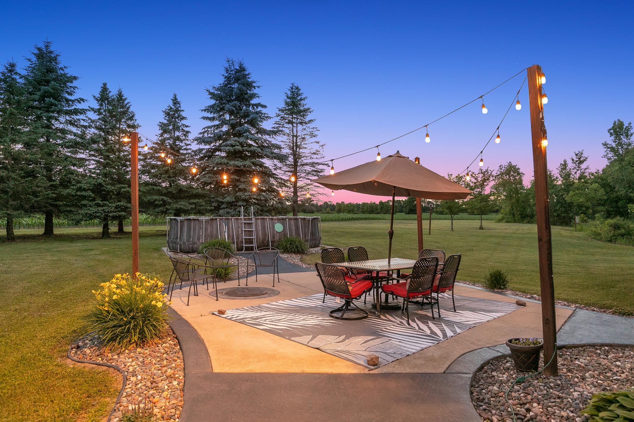 A deck off the main level extends to a gazebo and a large concrete patio, creating an ideal setting for entertaining or unwinding while taking in the peaceful surroundings.