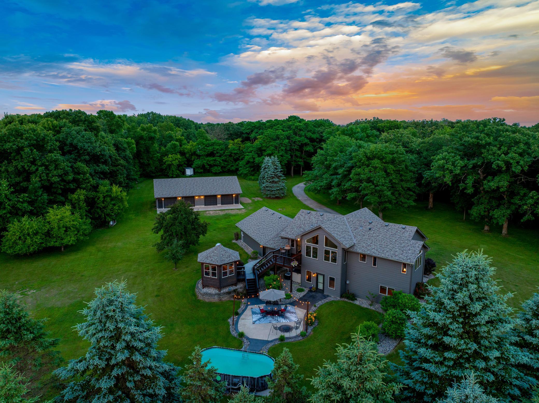 Expansive outdoor spaces, including a deck with a gazebo, a large patio, and a new pool, create an inviting setting for entertaining or unwinding, while the surrounding land provides room to roam and the unique ability to hunt on your own property.