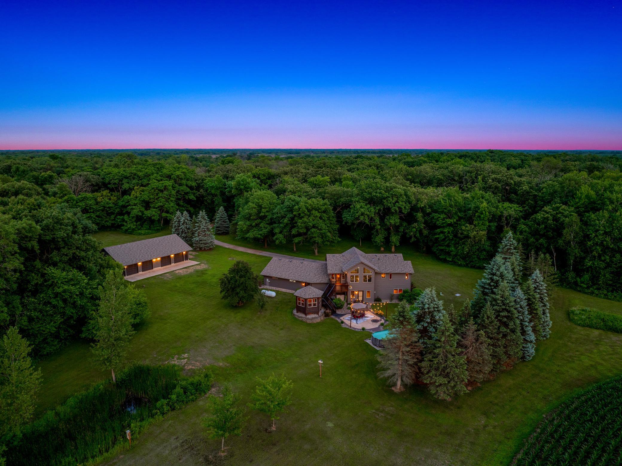 Expansive outdoor spaces, including a deck with a gazebo, a large patio, and a new pool, create an inviting setting for entertaining or unwinding, while the surrounding land provides room to roam and the unique ability to hunt on your own property.