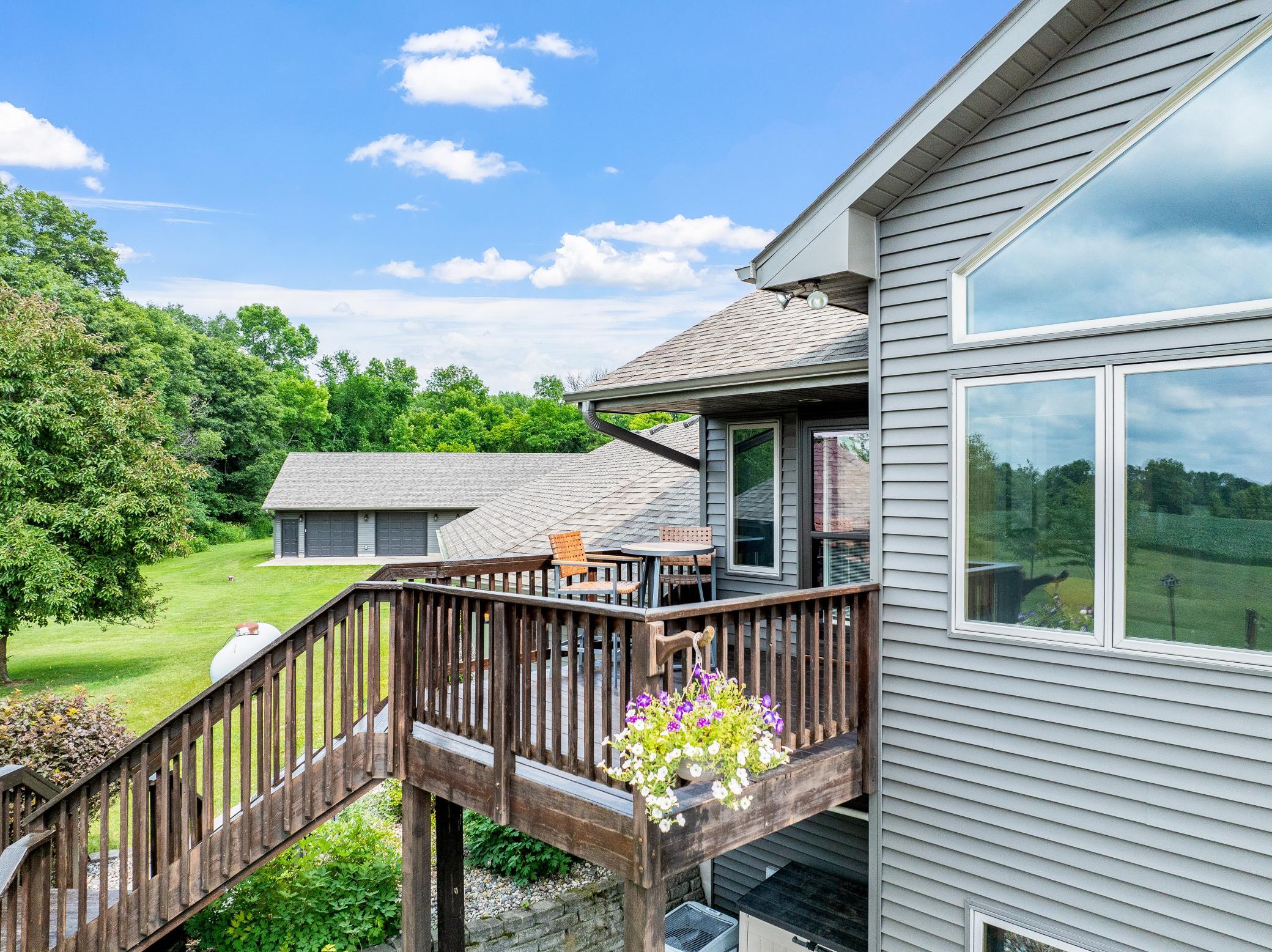 A deck off the main level extends to a gazebo and a large concrete patio, creating an ideal setting for entertaining or unwinding while taking in the peaceful surroundings.