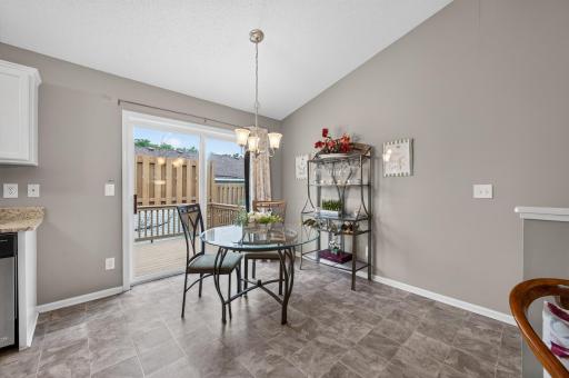 The dining area walks out to a private deck for effortless indoor-outdoor living.