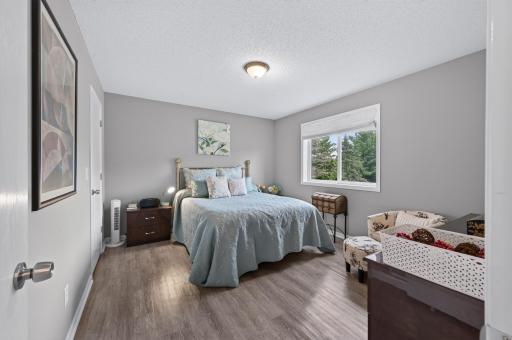 The primary bedroom is generous in size with neutral paint and abundant natural light.