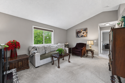 Upstairs, you'll find a bright and inviting living area with vaulted ceilings and abundant natural light.