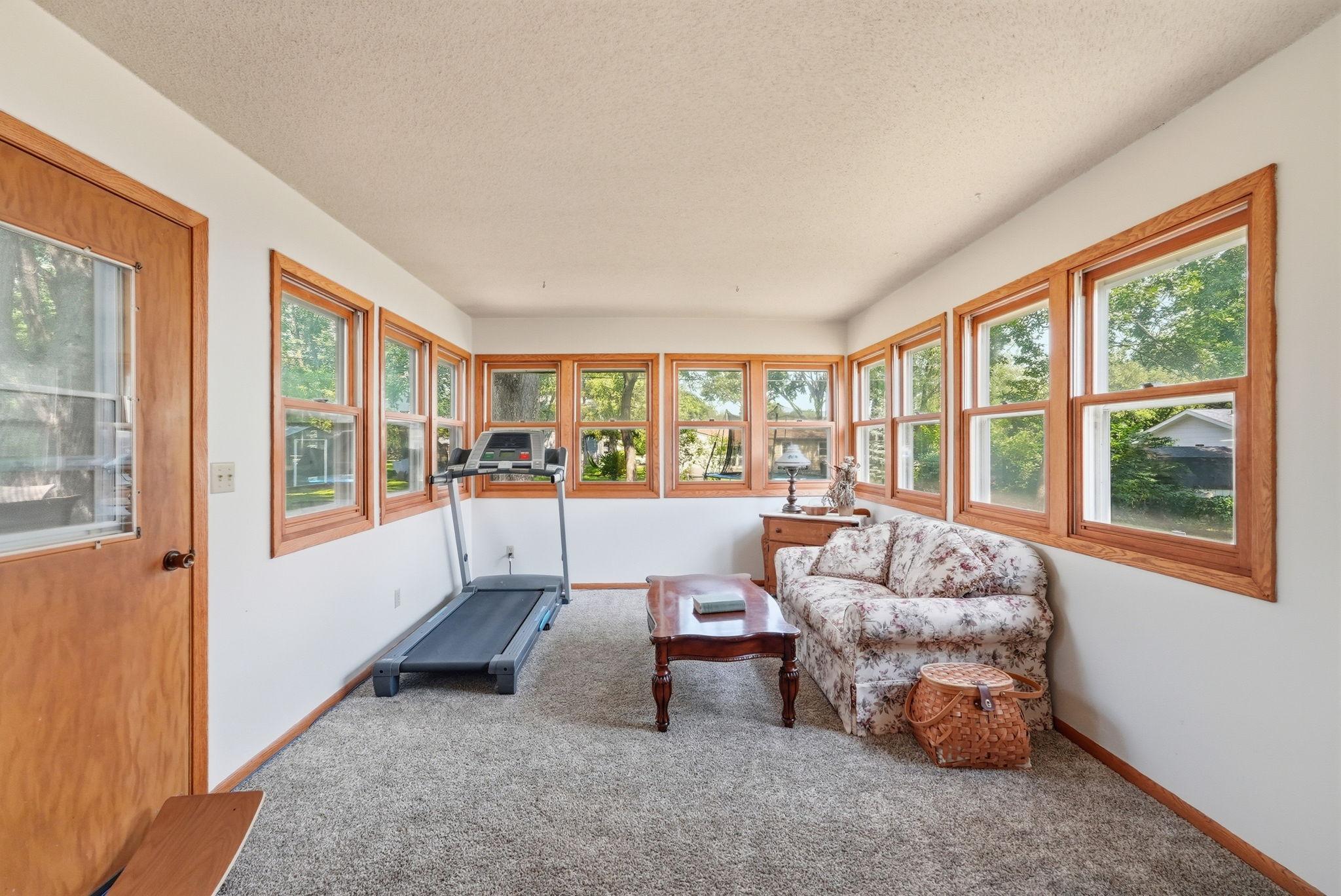 Sunroom extends your living space year-round and features a cozy freestanding gas fireplace, creating the perfect spot to relax with your morning coffee or unwind at the end of the day