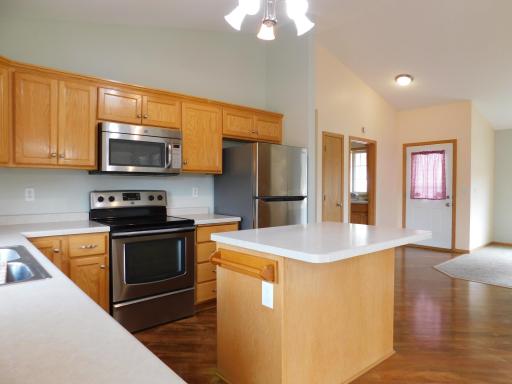 Kitchen with center island and vaulted ceilings.
