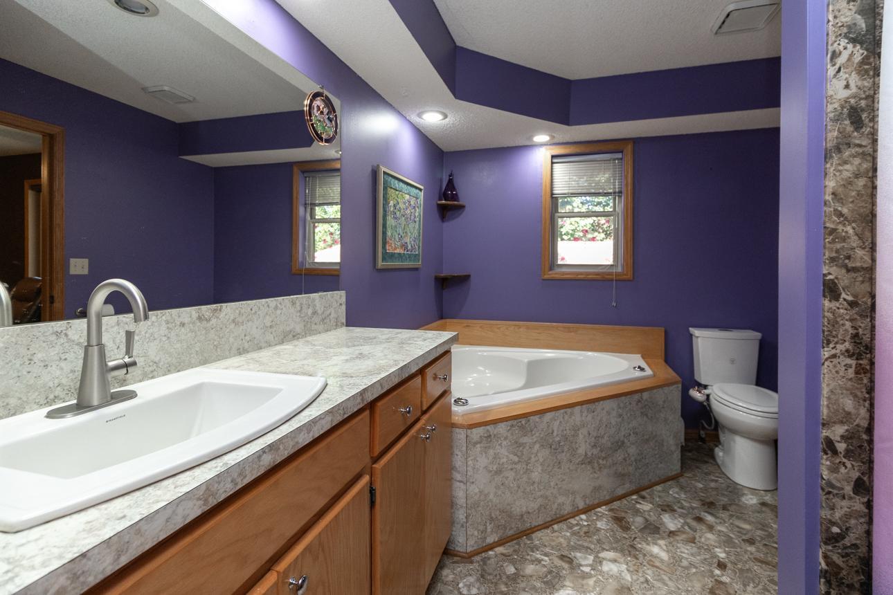 An oversized, jetted tub gives room for a luxurious bath, and an extra large vanity provides ample space for pampering
