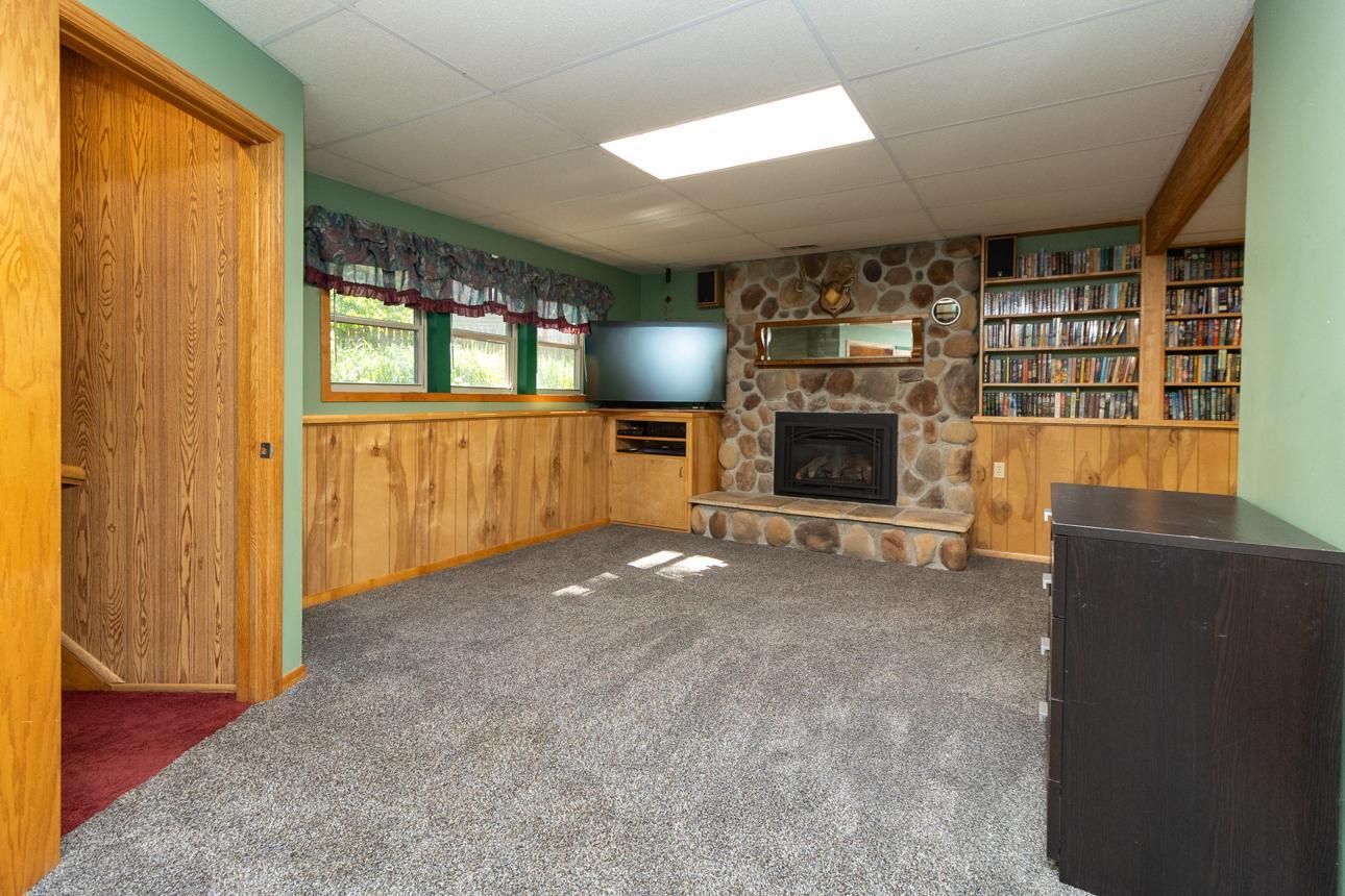 Lower level family room with stone-surround gas fireplace is the center of this cozy space.