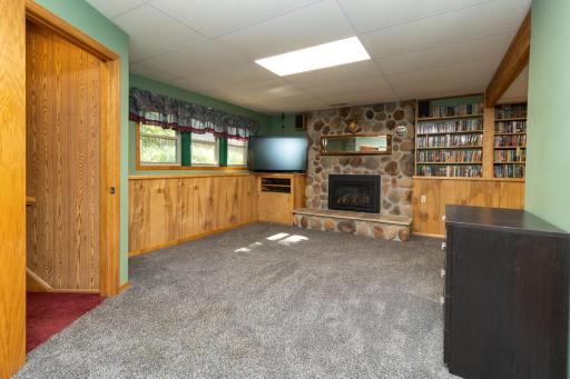Lower level family room with stone-surround gas fireplace is the center of this cozy space.
