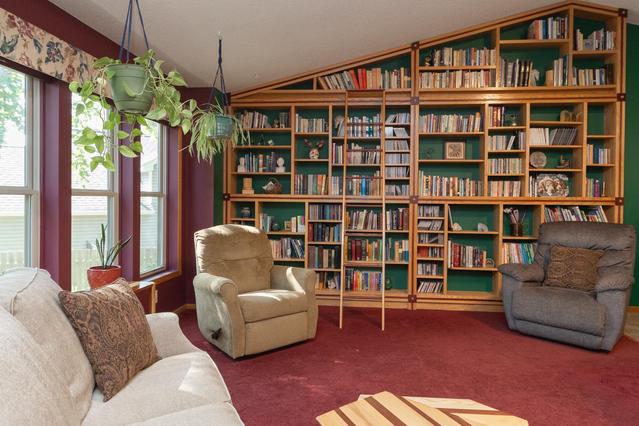 The main level of the home features a custom built bookcase with ladder