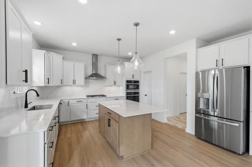 The kitchen has ease-of-access to the mudroom and flows seamlessly into the dining room