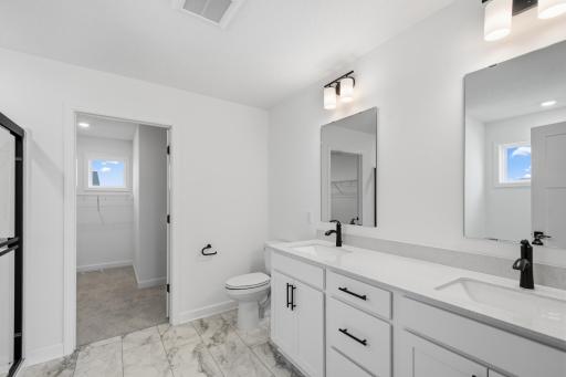 The en-suite bathroom has dual sinks to simplify any morning routine