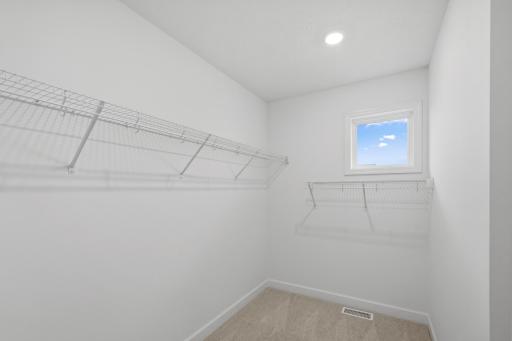 The walk-in closet offers ample space and storage