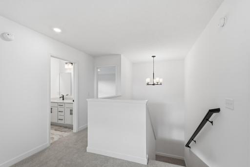 The upstairs halls make for easy access to the loft, laundry room, and bathroom.