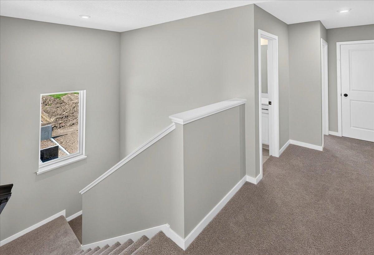PHOTO OF A DIFFERENT HOME WITH SIMILAR PLAN & FINISHES. Upper floor hallway.