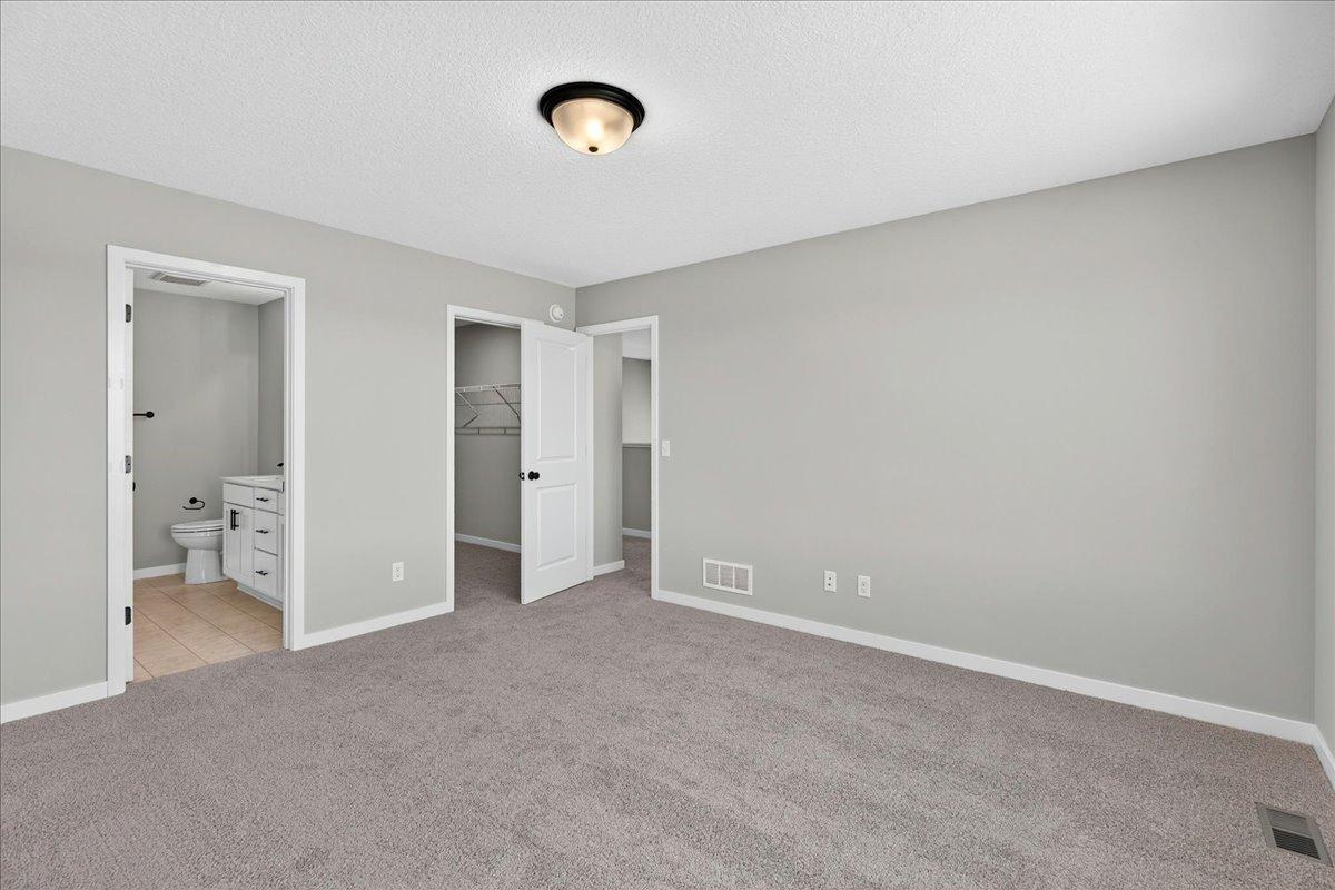 PHOTO OF A DIFFERENT HOME WITH SIMILAR PLAN & FINISHES. Primary Suite.