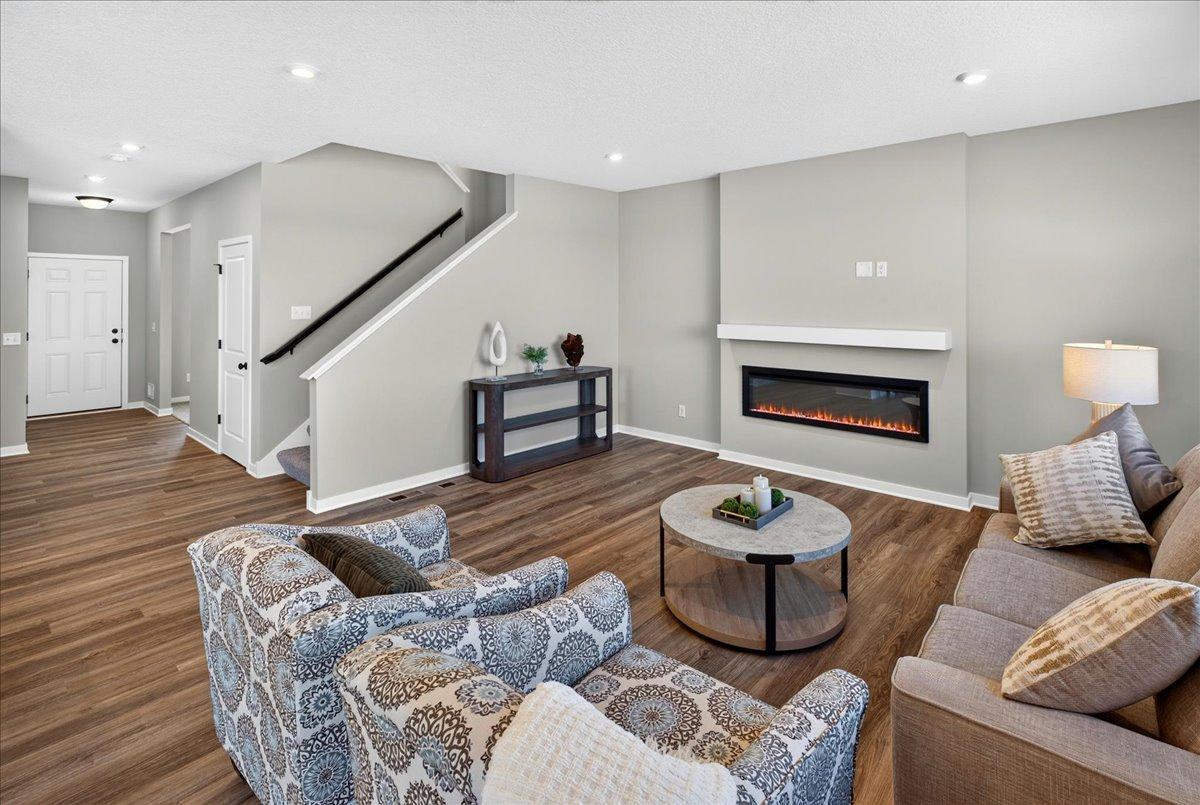 Great Room features a fireplace and mantle. PHOTO OF A DIFFERENT HOME WITH SIMILAR PLAN & FINISHES.