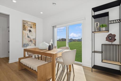 (Photo of a decorated model, actual homes finishes will vary) Soaked in natural sunlight, the homes eat-in dining room has ample room for a dining table located in the heart of the home.