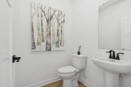 (Photo of a decorated model, actual homes finishes will vary) Convenient main level powder bath.