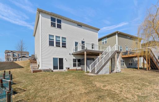 This expansive, maintenance-free composite deck offers a private, elevated vantage point overlooking a protected nature preserve and tranquil pond.